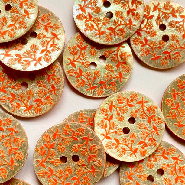 Decorative buttons with floral patterns on a white background