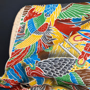 Colorful fabric with parrot pattern on a dark background