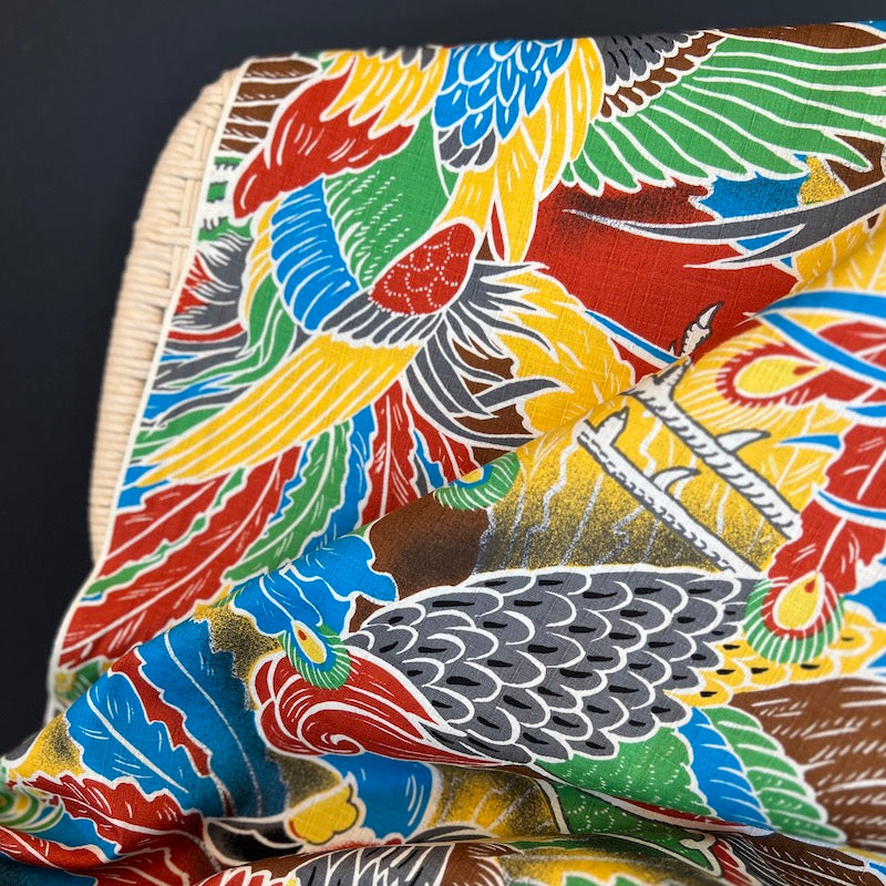 Colorful fabric with parrot pattern on a dark background