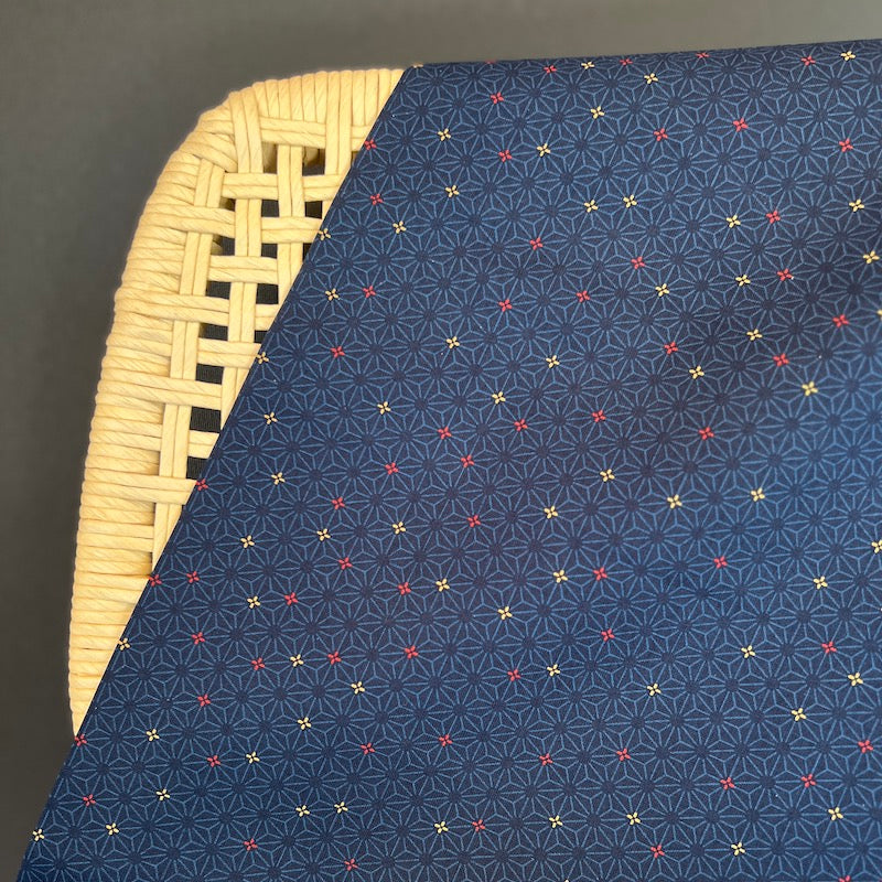 Navy fabric with colorful geometric pattern on a wicker chair