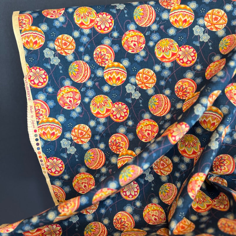 Colorful fabric with a pattern of round shapes on a blue background
