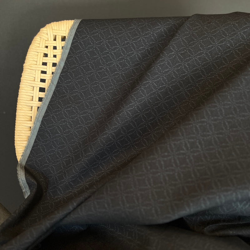 Dark textured fabric on a dark background