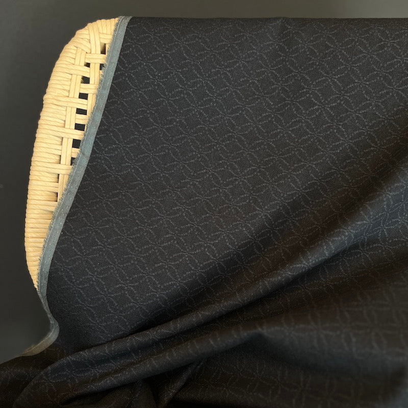 Black textured fabric on a dark background