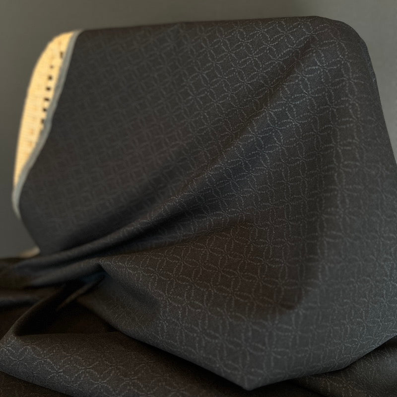 Black textured fabric with a subtle pattern on a dark background