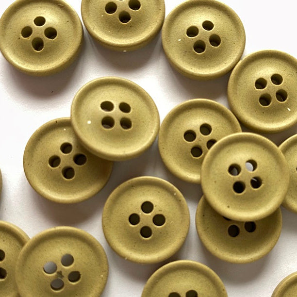 Collection of beige buttons on a white background