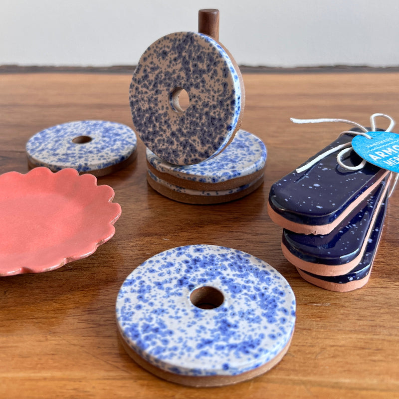 Speckled blue and pink ceramic items on a wooden surface