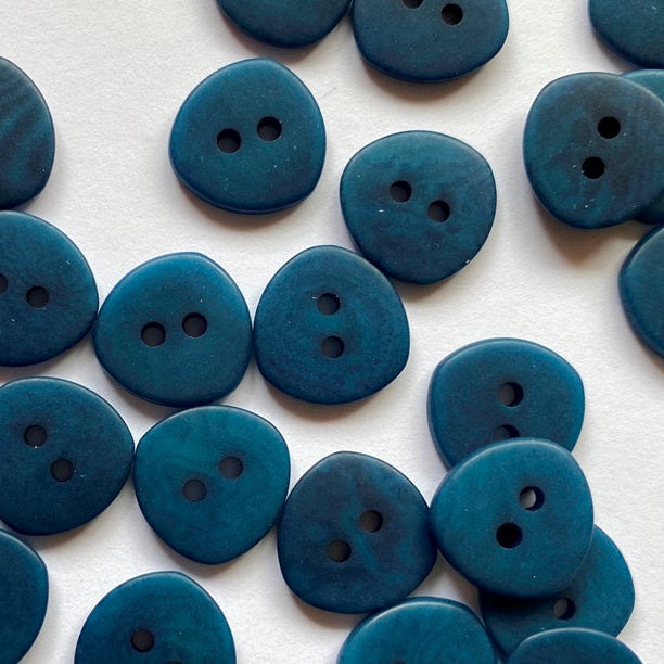 Blue buttons with two holes on a white background