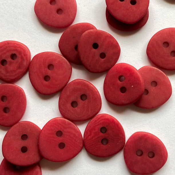 Red buttons with two holes on a white background