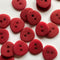 Red buttons with two holes on a white background