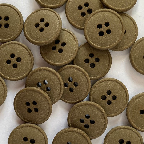 Brown buttons with four holes on a white background