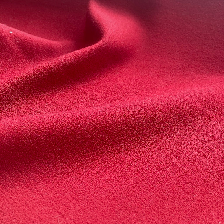 Close-up of red fabric with a textured surface