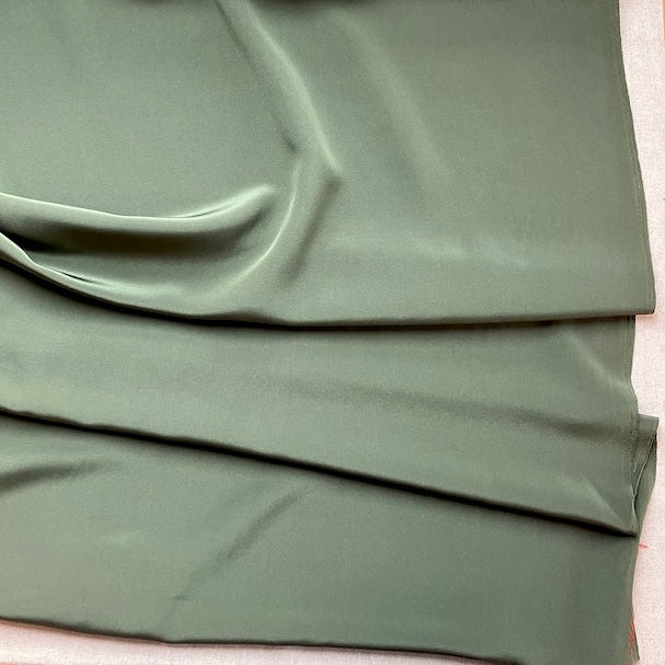 Green fabric on a wooden surface