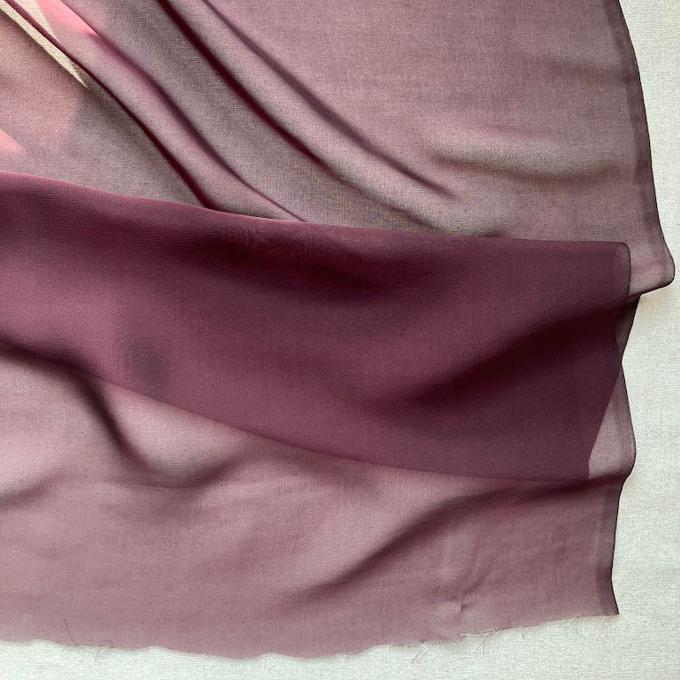 Maroon fabric draped over a white surface