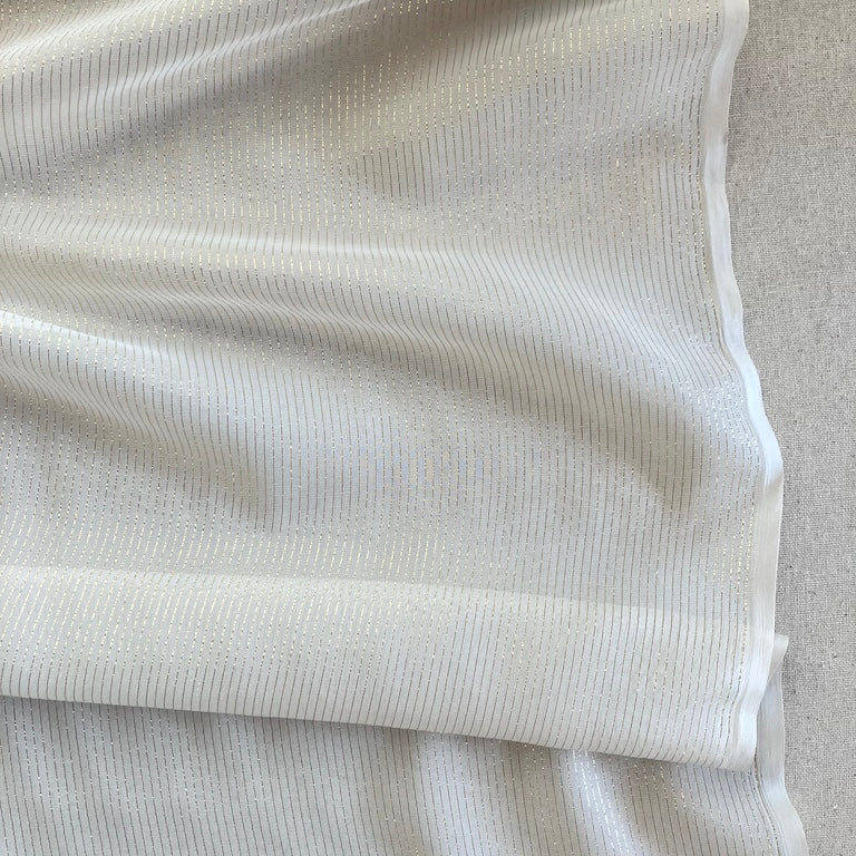 Close-up of textured white fabric on a light gray background