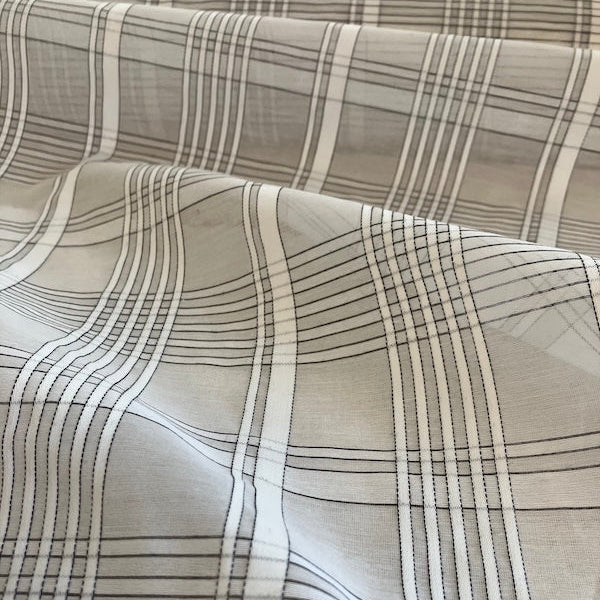 Close-up of fabric with a plaid pattern in neutral colors