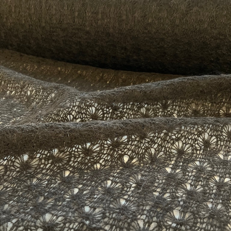 Close-up of textured fabric with a lace overlay