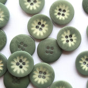 Green buttons with floral patterns on a white background