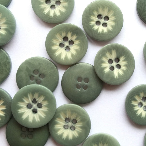 Green buttons with floral patterns on a white background