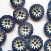Blue buttons with white floral patterns on a white background
