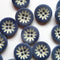 Blue buttons with white floral patterns on a white background