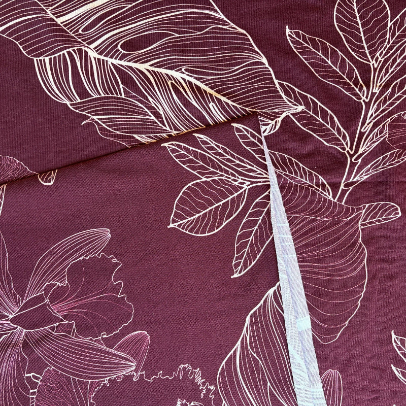 Close-up of a purple fabric with white floral patterns