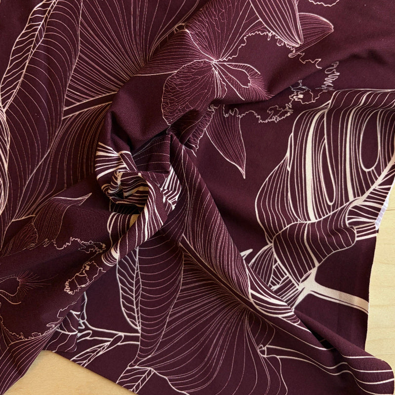 Close-up of fabric with intricate leaf pattern on a dark background
