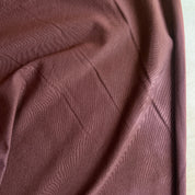 Close-up of brown fabric with a diamond pattern