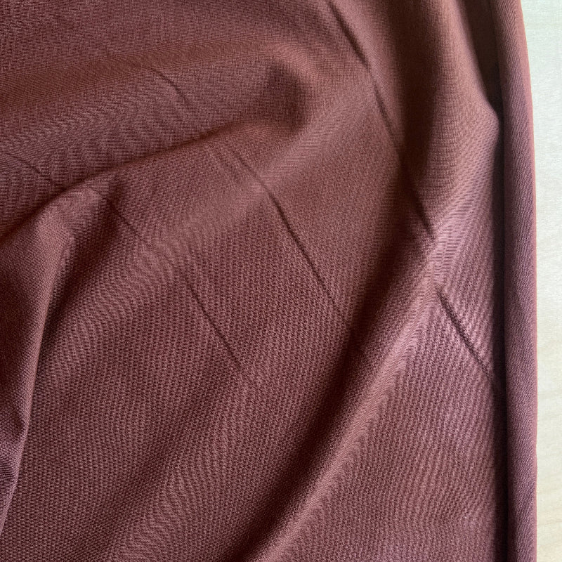Close-up of brown fabric with a diamond pattern