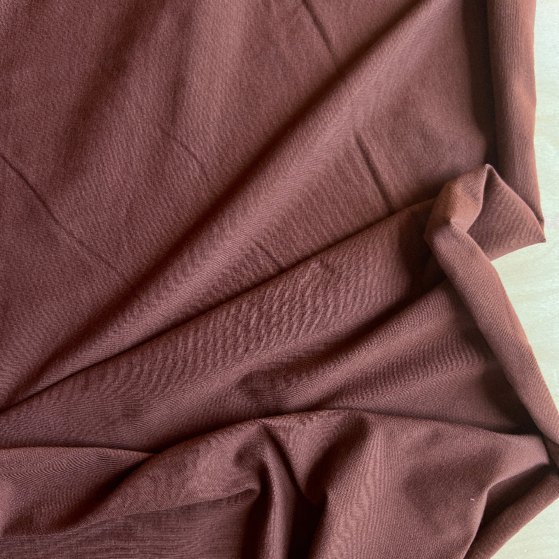 Close-up of brown fabric with folds