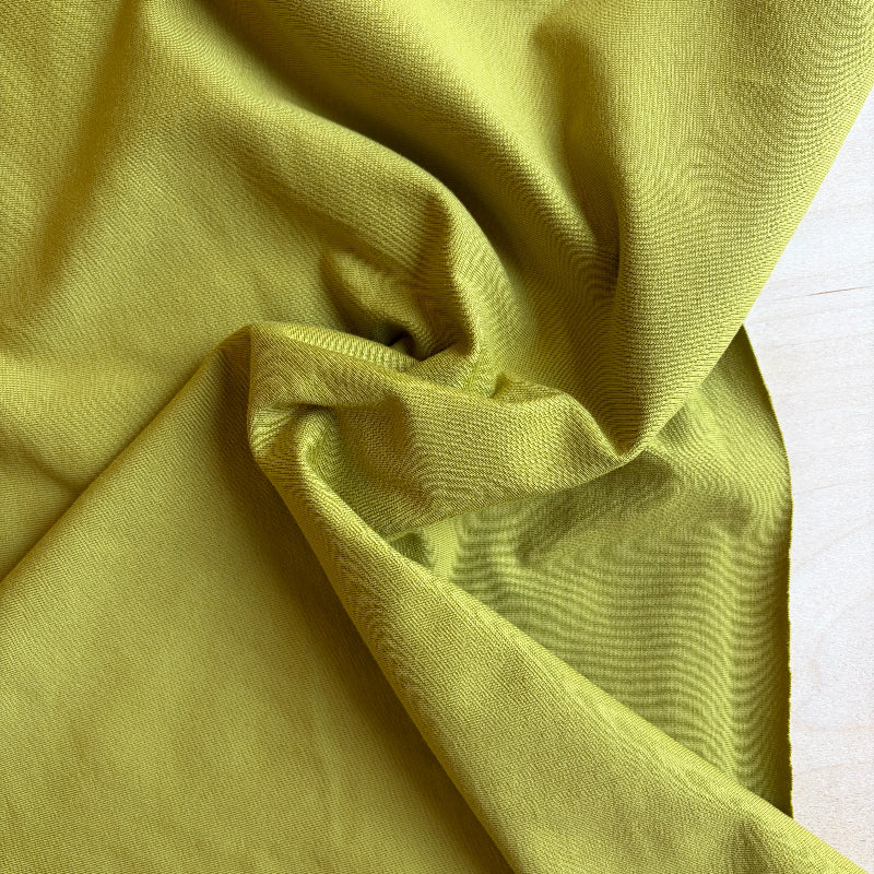 Close-up of lime green fabric with folds