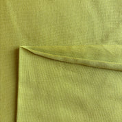 Close-up of lime green fabric with a slight texture