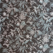 Floral patterned fabric with metallic accents on a dark background