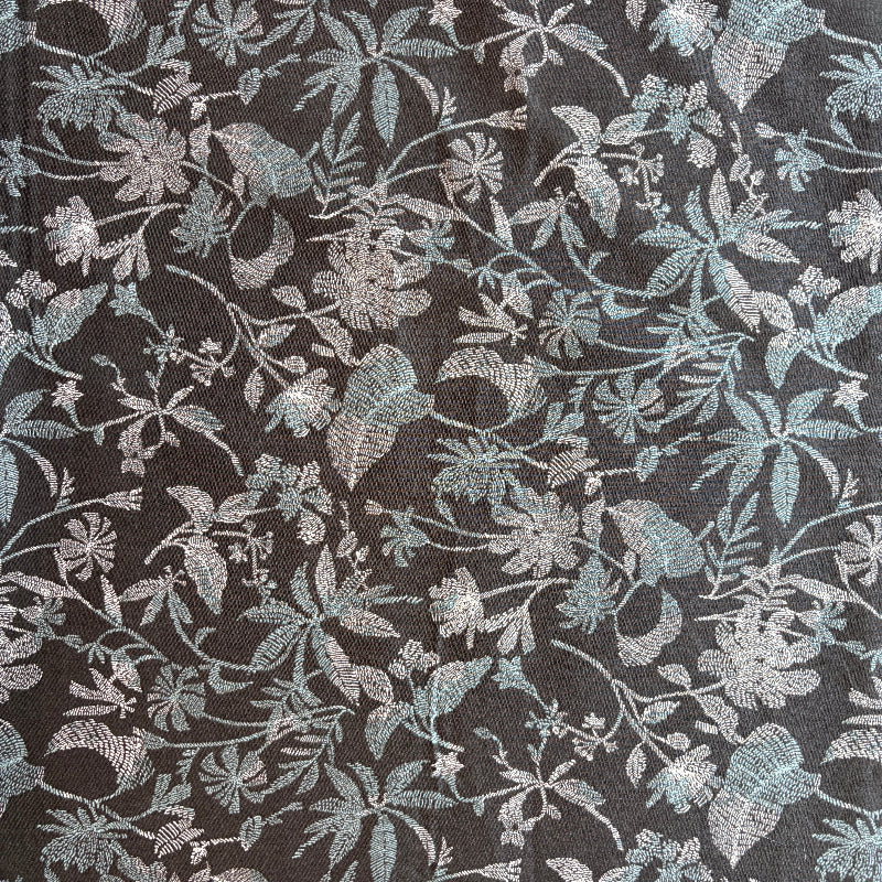 Floral patterned fabric with metallic accents on a dark background