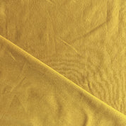 Close-up of ochre fabric with a subtle texture