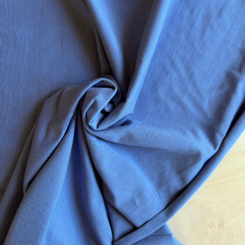 Close-up of blue fabric with a wooden surface underneath