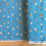 Blue fabric with cartoon character pattern on a wooden surface