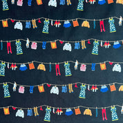Colorful miniature clothesline with various garments on a dark background