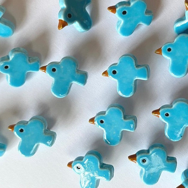 Pattern of blue bird-shaped buttons on a white background