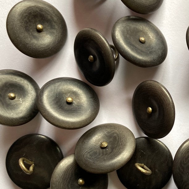Grey buttons with gold centers on a white background