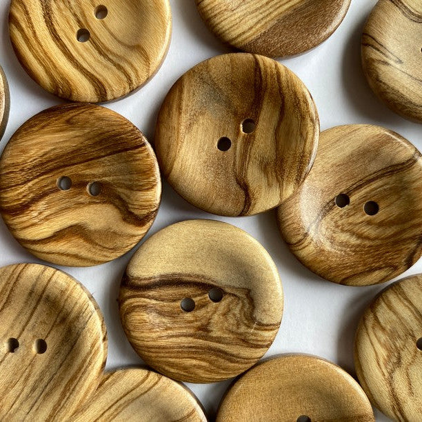 Wooden buttons with a natural grain pattern on a white background
