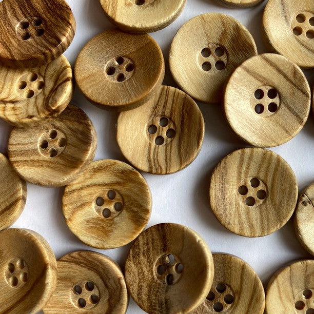 Wooden buttons with a natural finish on a white background