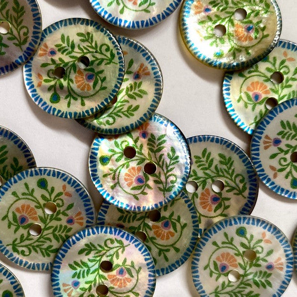 Collection of decorative buttons with floral patterns on a white background