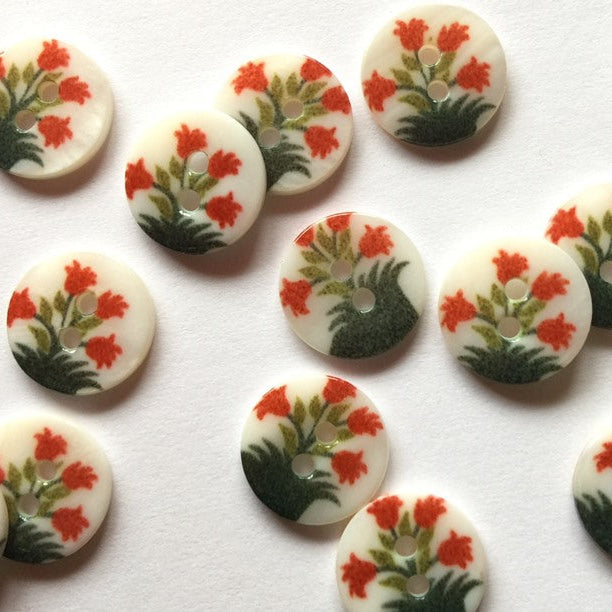 Decorative buttons with floral design on a white background