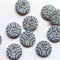 Blue buttons with white bead patterns on a white background