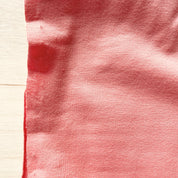 Close-up of red fabric with a textured surface