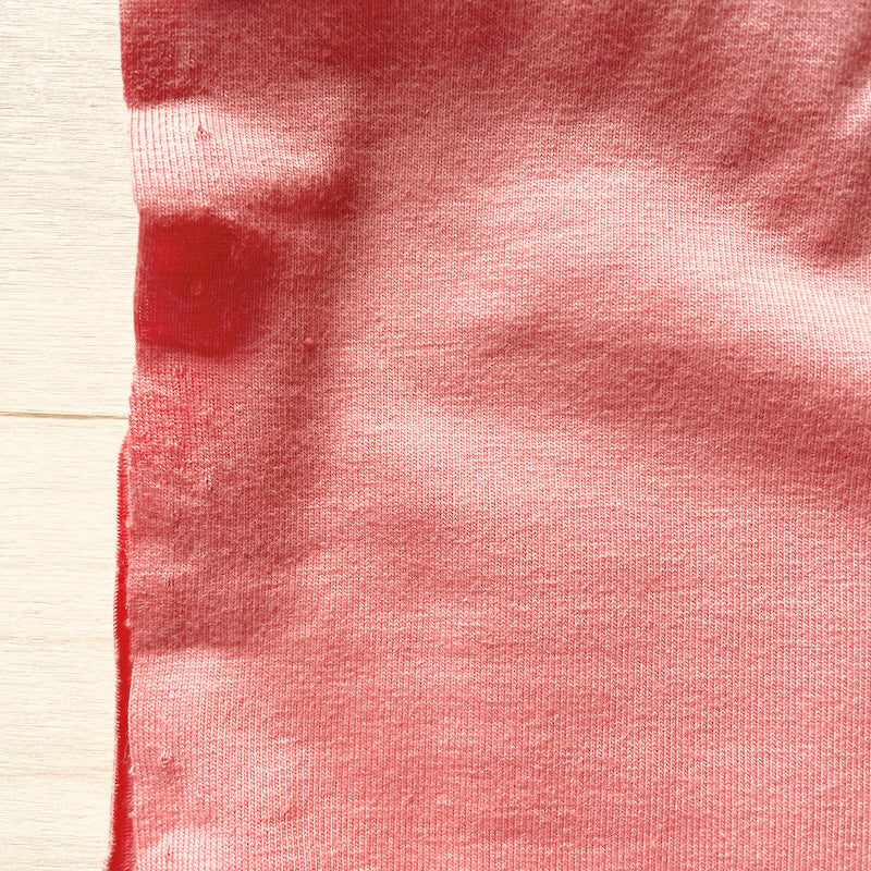 Close-up of red fabric with a textured surface