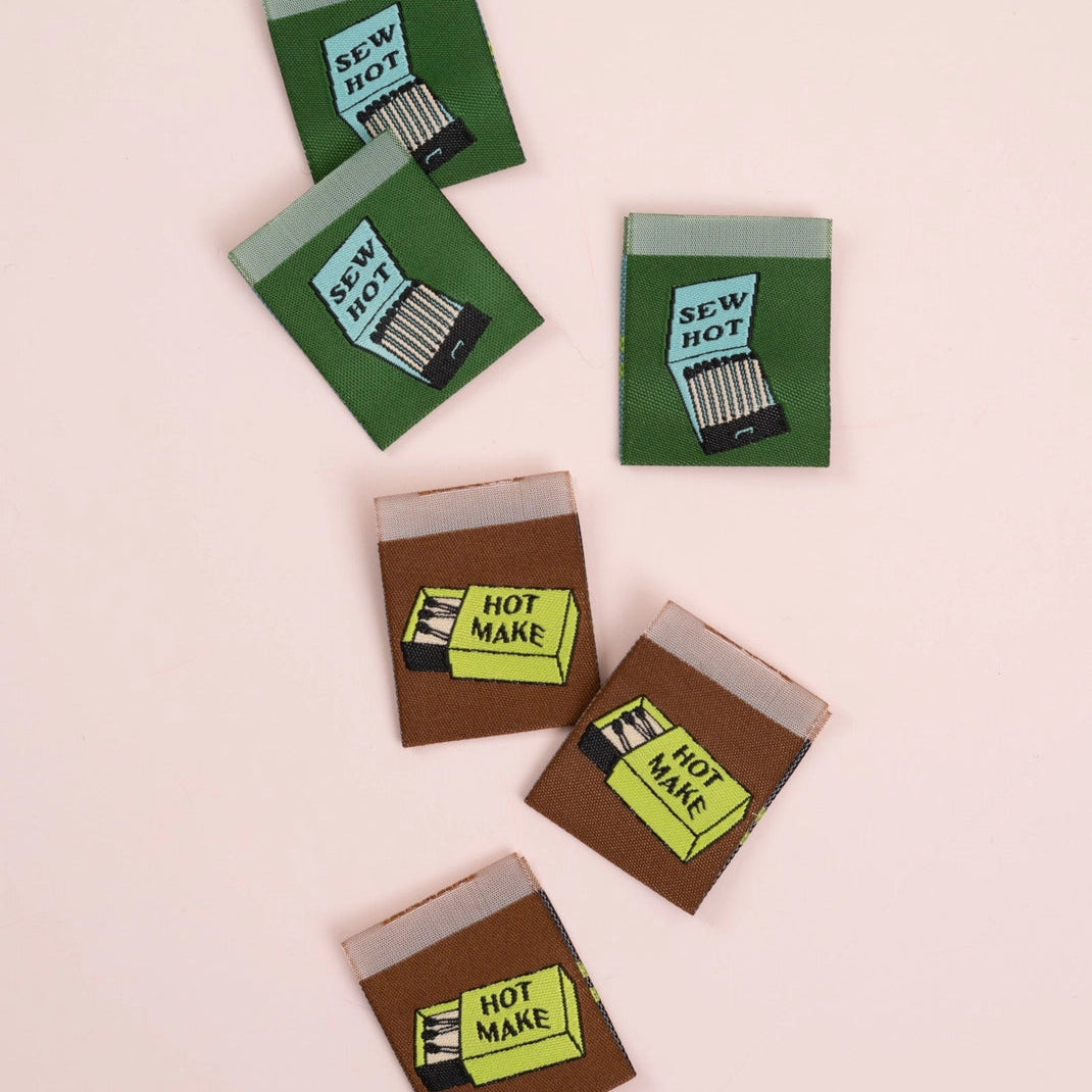 Labels with matchbox design with 'Sew Hot' and 'Hot Make' text on a light pink background