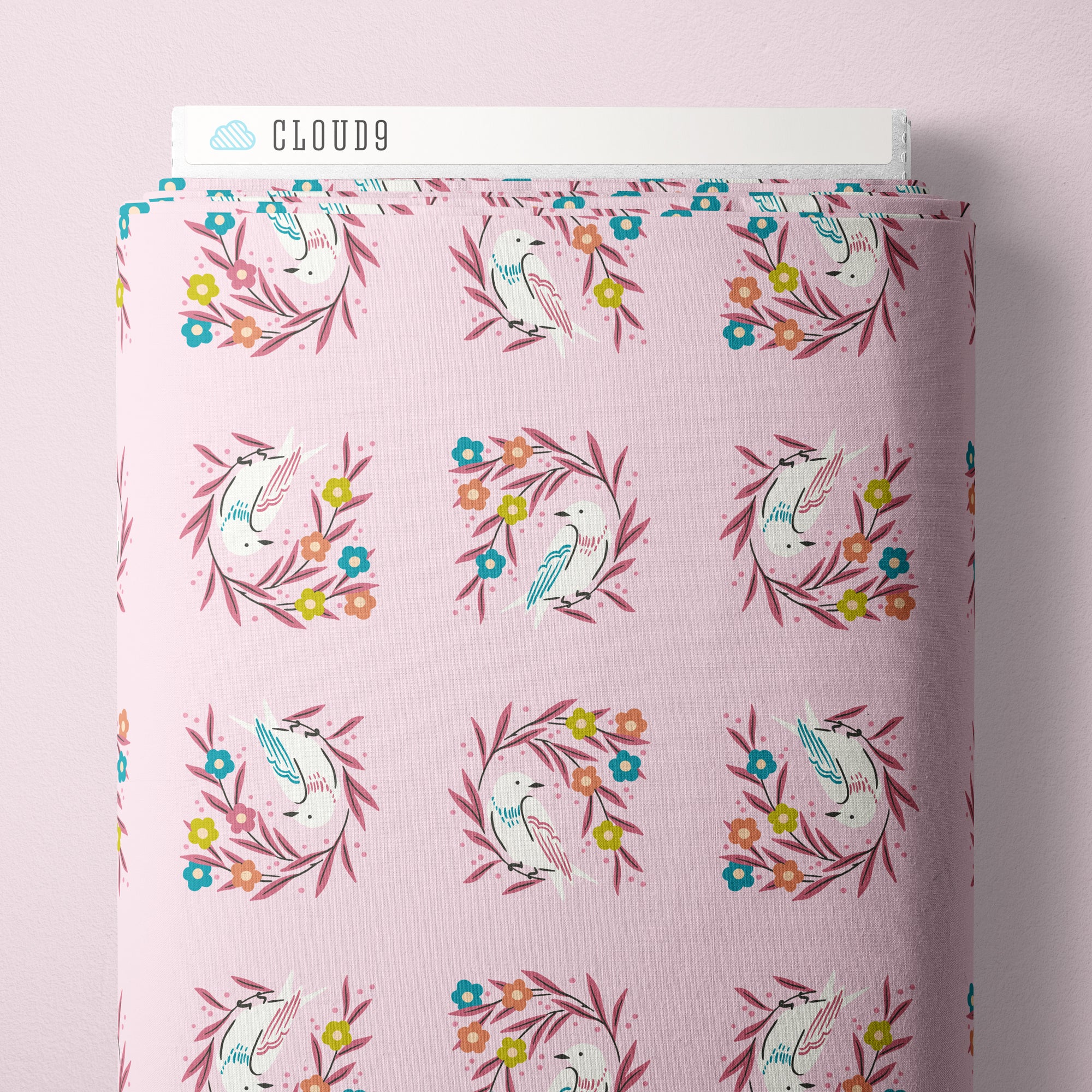 Fabric with light pink background and white bird sitting on a dark pink branch.