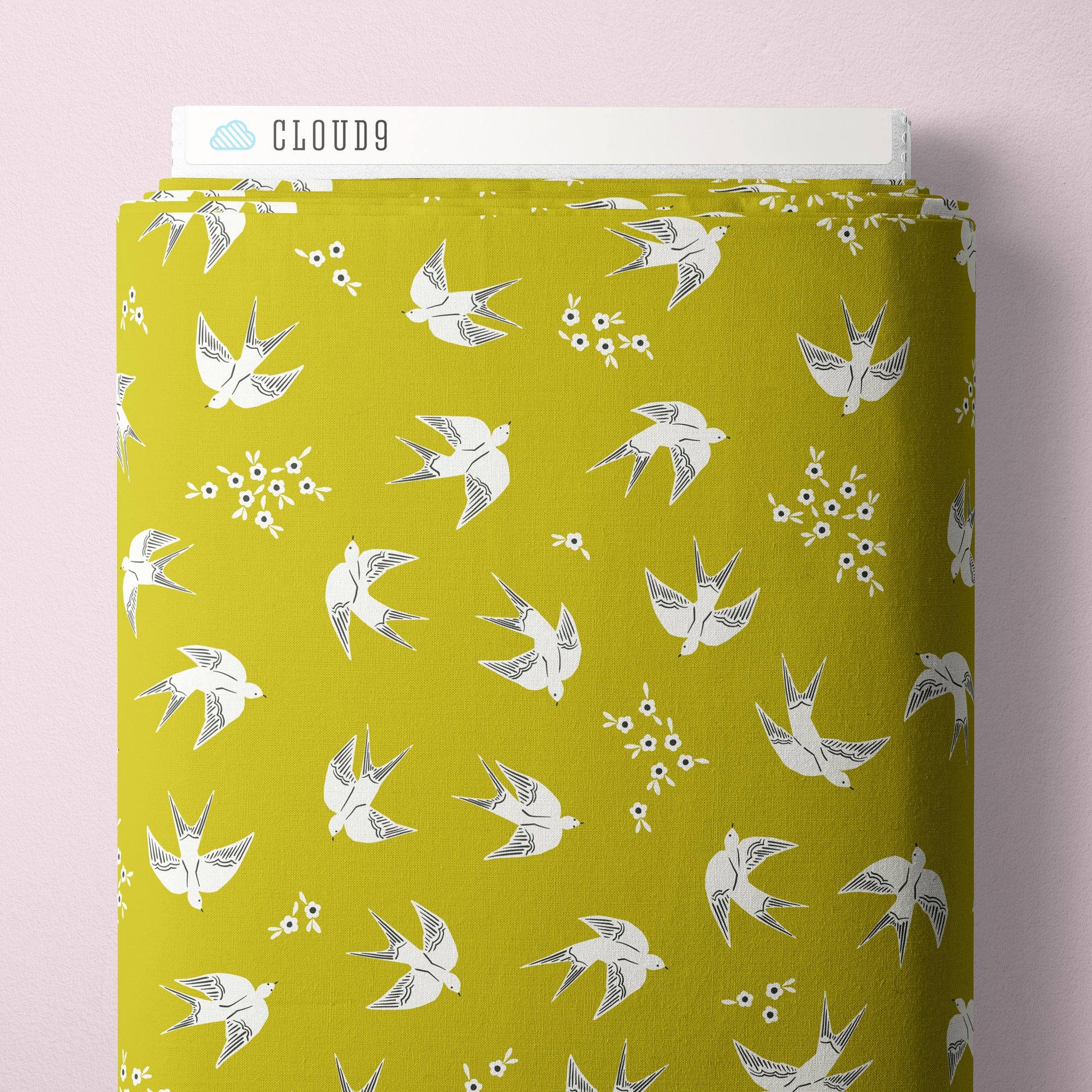 Olive green fabric with white birds and flowers.