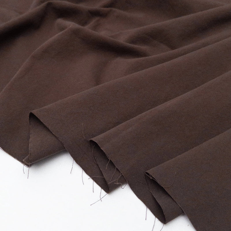 Brown fabric with visible stitching on a white background